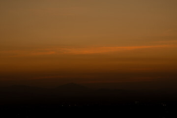 Night natural scence, Good night The golden light from the setting sun, there is still a beautiful golden light and mountains in the shadows. The light from light bulbs in homes becomes more prominent