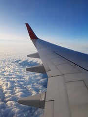 Airplane wing in blue sky