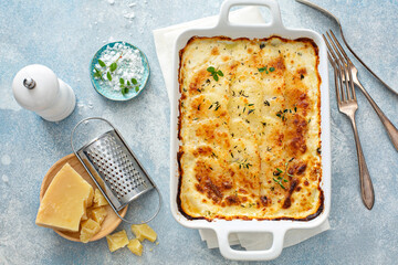 Cheesy scalloped potatoes with thyme and parmesan