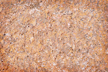 red stone rough with holes texture abstract background