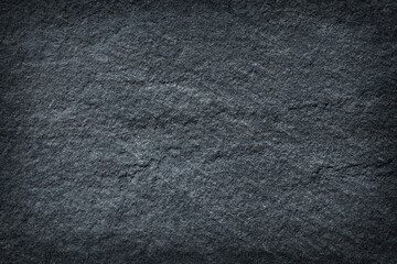 Dark grey / black slate stone background or texture.