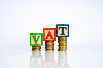 ooden cube and letter "VAT" with financial concept.W