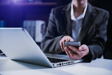 business documents on office table with smart phone and digital tablet and graph financial and man working.