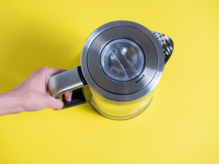 electric metal kettle in silver color with different modes of water heating on a bright yellow background.
