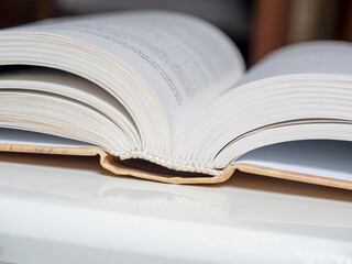 a thick open book lies on a white background. The concept of learning and knowledge