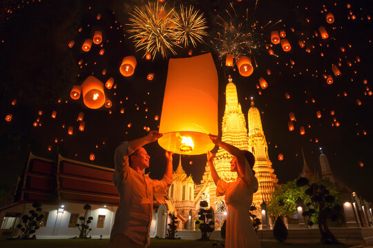 Traveler couple enjoy yeepeng floating lantern in loi kratong festival