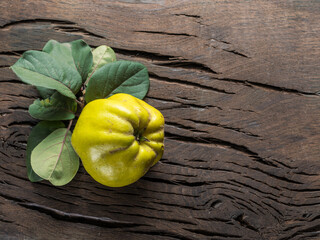 Ripe golden yellow quince fruit on wood. Organic fruit on old table. Top view.