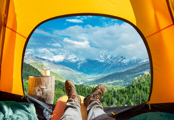 Spectacular view of nature from open tent entrance. The beauty of romantic trekking and camping.