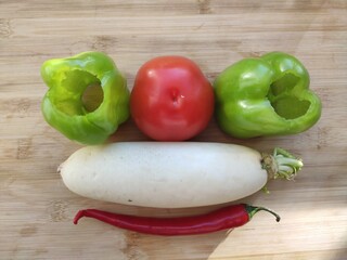 Fresh organic fruits and vegetables on wooden background