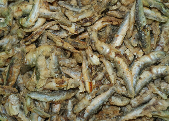 Many fried anchovy fish at the restaurant