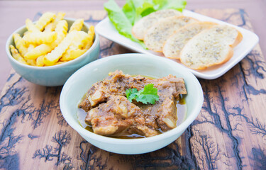 Pork stew serve with French fries and garlic bread