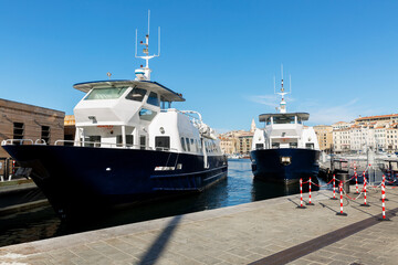 Ships at the pier on a sunny day against the backdrop of a bright blue sky.