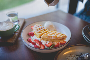 waffle pancake desert with vanilla ice cream, fresh strawberry and honey syrup - 408016774