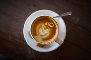 Latte hot coffee with foam milk art on a wooden table - 408016930