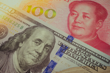 Global world economy crisis situation, US vs China trade war and currency war concept. US dollar and Chinese yuan renminbi banknotes background. US increases tariffs of Chinese goods