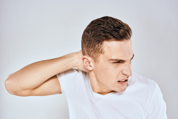 Fototapeta premium Man in white t-shirt displeased facial expression gesturing with hands studio lifestyle