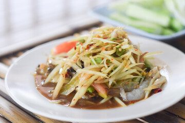 Papaya salad with shrimp in white dish. Thai food delicious and popular