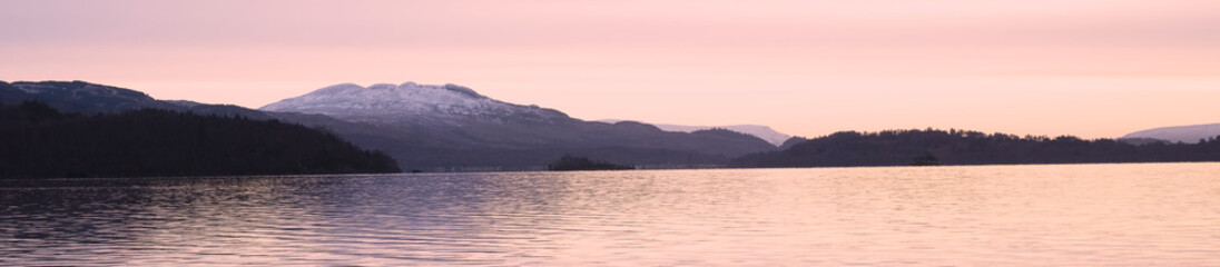 Ben Lomond at Loch Lomond during pink sunrise sky in Scotland