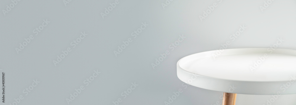 Poster white modern round table at grey house wall background,mockup space backdrop for display of product 