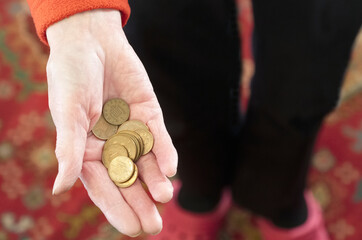 Poor society elderly senior hand of senior person full of worthless copper coins