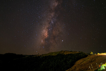 Milkyway galaxy with starlight over the mountain  at Nan province ,Thailand. Starlight on the sky at night.