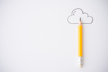 Yellow pencil and outline cloud on white paper background copy space. Creative idea, imagination and education concept. Imagination is more important than knowledge.