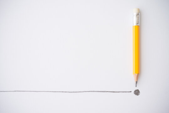 Flat lay of yellow colour pencil write line and end point on white paper background copy space. Business conclusion, creative idea, imagination and education concept.