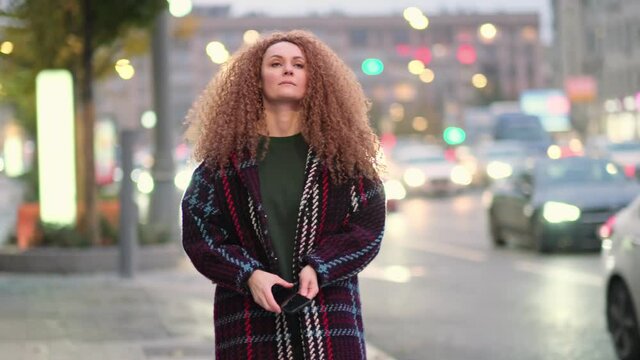 young woman walks around the city, waiting for her friend, lifestyle in a beautiful city. Slow motion video. stock footage