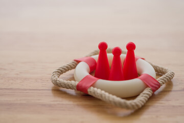 Health insurance or life insurance business and health care concept. People model in lifebuoy on...
