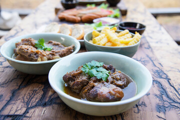 Beef and pork stew with French fries and others food recipes on wooden table, food meal preparing ready for eat concept