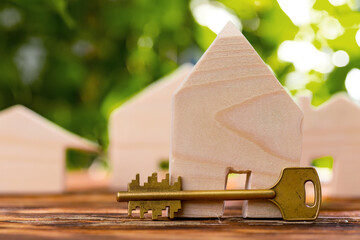 Wooden toy house and house keys close up