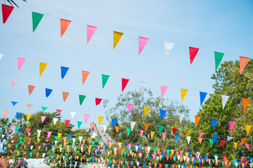 Colorful bunting decoration in outdoor summer festival party. Vintage festival and celebration concept. - obrazy, fototapety, plakaty