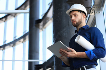 Shot of a engineer using a digital tablet on a construction site. This software help me to keep track of everything.