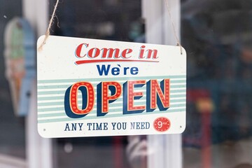 Open sign hanging on the front door of the store