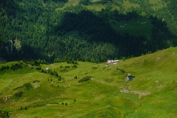 wonderful green hills with a alpine hut view from above