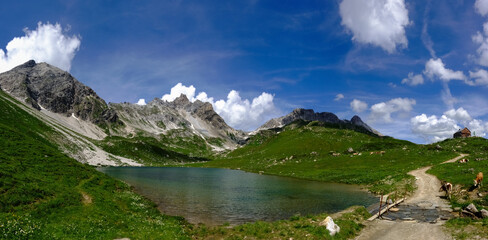 Naklejka na ściany i meble wonderful mountain valley with a lake and blue sky panorama