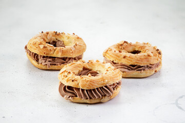 Classic French dessert Paris Brest with chocolate cream