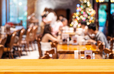 Empty wooden table background of free space for your on blur cafe restaurant in dark background, For montage product display