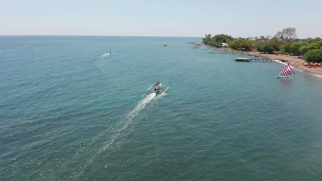 Drone Flight Tracking Outrigger Boat Over Blue Sea
