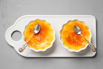 Fresh homemade creme brulee with burnt sugar on gray background. Top wiev