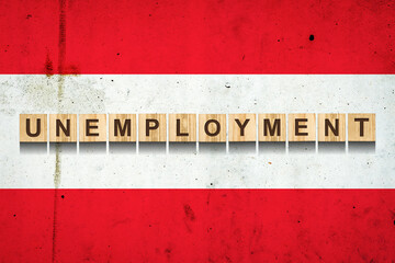 Unemployment. The inscription on wooden blocks on the background of the Austria flag. Unemployment growth. Business.