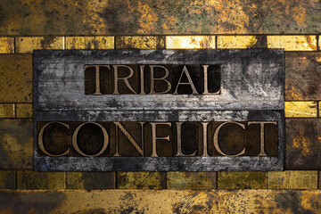 Tribal Conflict text on vintage textured silver grunge copper and gold background