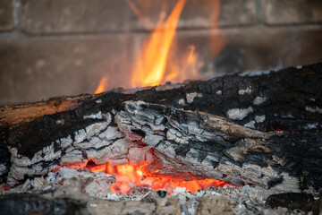 flaming fire in an extinguished stone fireplace, horizontal