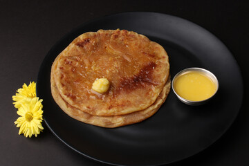 Puran Poli, also known as Holige, is an Indian sweet flatbread from India consumed mostly during Holi festival. Served in a plate with pure Ghee.