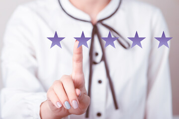 The girl leaves a review in the mobile app, puts a rating icon with stars