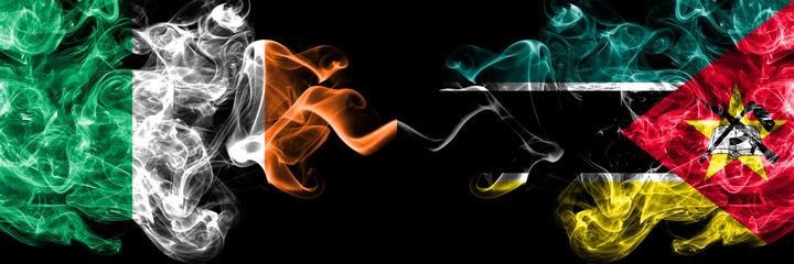 Republic of Ireland, Irish vs Mozambique, Mozambican smoky mystic flags placed side by side. Thick colored silky abstract smoke flags.