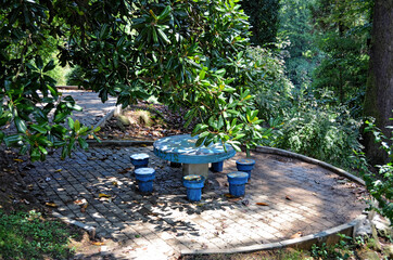 blue stone table with chairs in the botanical garden