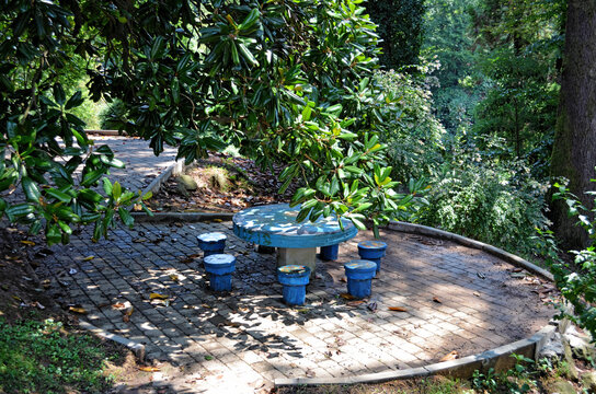 Blue Stone Table With Chairs In The Botanical Garden