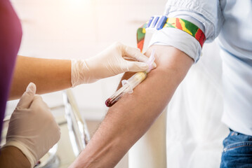Obraz na płótnie Canvas Nurse taking a patient's blood sample at lab