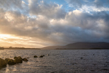 Stunning landscape image of Milarrochy Bay on Loch Lomond in Scottish Highlands with stunning Winter evening ligh